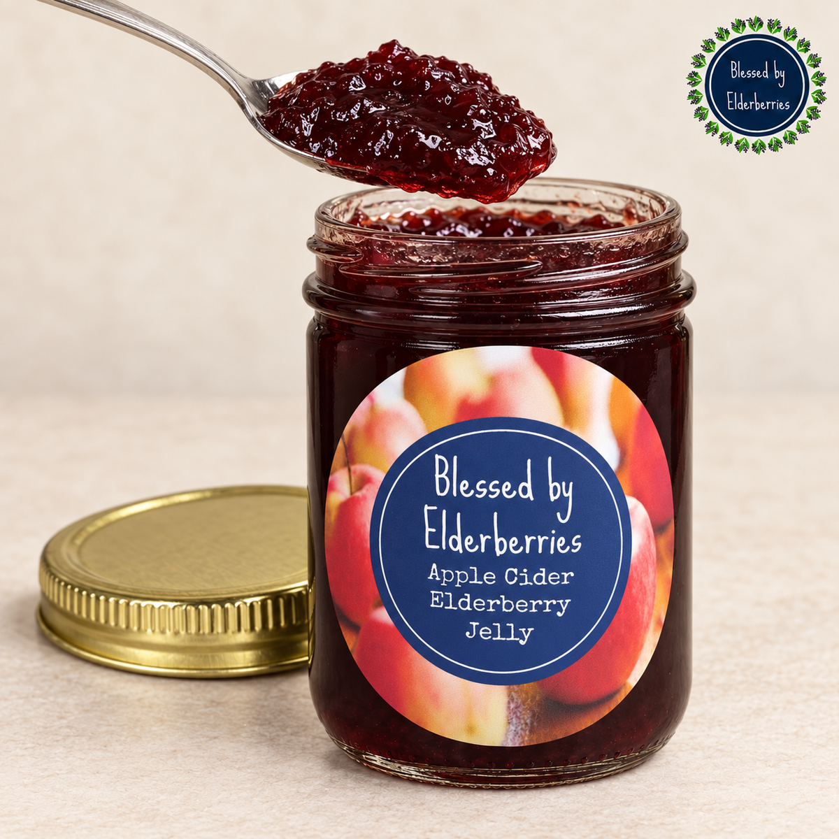 Spoonful of deep burgundy Apple Cider Elderberry Jelly above an open jar