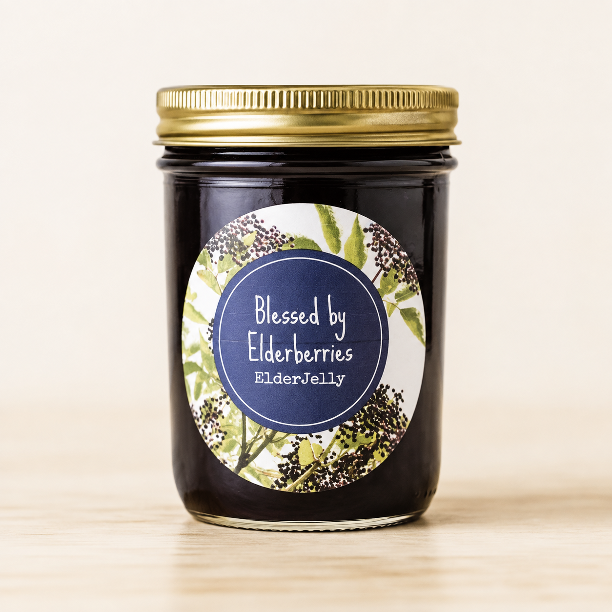 8 oz jar of Blessed by Elderberries Elderberry Jelly with a gold lid and dark purple elderberry jelly inside